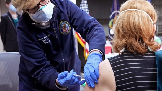 A healthcare worker administers a dose of the Covid-19 vaccine at a Veterans Affairs medical centre Covid-19 vaccination site in Washington, D.C. (Bloomberg)