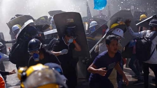 Protesters are dispersed as riot police fire tear gas during a demonstration in Yangon, Myanmar, Monday, March 8, 2021. Myanmar security forces continued to clamp down on anti-coup protesters, firing tear gas to break up a crowd of around 1,000 people who were demonstrating in the capital, Naypyitaw. The protesters deployed fire extinguishers to create a smoke screen as they fled from authorities. (AP Photo) (AP) Protesters are dispersed as riot police fire tear gas during a demonstration in Yangon, Myanmar, Monday, March 8, 2021. Myanmar security forces continued to clamp down on anti-coup protesters, firing tear gas to break up a crowd of around 1,000 people who were demonstrating in the capital, Naypyitaw. The protesters deployed fire extinguishers to create a smoke screen as they fled from authorities. (AP Photo) (AP)