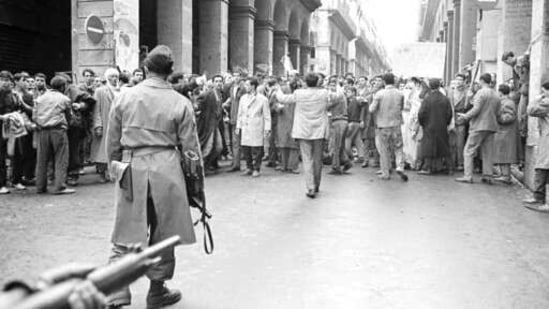 In this Dec.14, 1960 file photo, armed French soldiers, foreground, face a shouting mob of Algerians at an entrance to the Casbah native quarter in Algiers. French President Emmanuel Macron announced a decision to speed up the declassification of secret documents related to Algeria's seven-year war of independence from 1954 to 1962. (AP) In this Dec.14, 1960 file photo, armed French soldiers, foreground, face a shouting mob of Algerians at an entrance to the Casbah native quarter in Algiers. French President Emmanuel Macron announced a decision to speed up the declassification of secret documents related to Algeria's seven-year war of independence from 1954 to 1962. (AP)