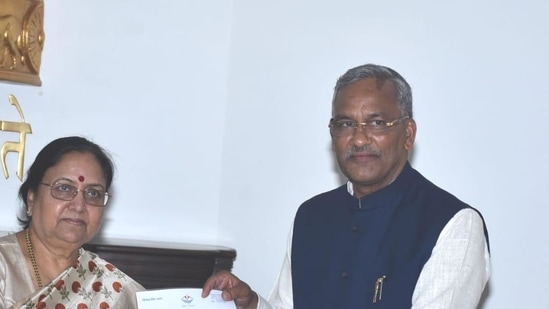 Trivendra Singh Rawat (right) on Tuesday submitted his resignation to Governor Baby Rani Maurya. (HT Photo) 