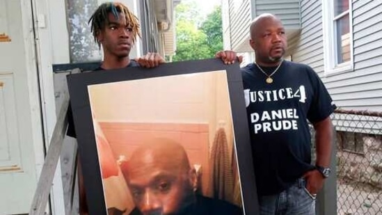 Joe Prude, right, brother of Daniel Prude, and Daniel's nephew Armin, stand with a picture of Daniel Prude in Rochester, NY. (AP) Joe Prude, right, brother of Daniel Prude, and Daniel's nephew Armin, stand with a picture of Daniel Prude in Rochester, NY. (AP)