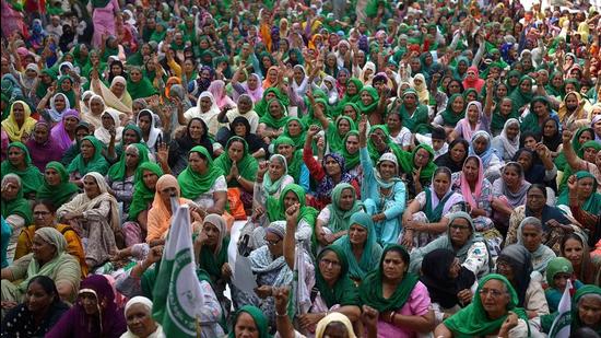 Women join the protesting farmers at Tikri border in New Delhi on March 8. (AFP)