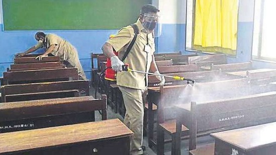 Employees sanitise a classroom PRAFUL GANGURDE/ HT PHOTO