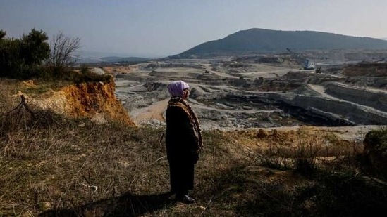Tayyibe Demirel, 64, stands at the edge of her olive grove and watches the open-pit coal mine in Turgut village near Yatagan in Mugla province, Turkey, on February 25.(Umit Bektas / REUTERS)