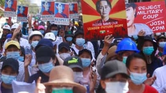 Anti-coup protesters hold up images of deposed leader Aung San Suu Kyi as they gather in Yangon, Myanmar. (AP) Anti-coup protesters hold up images of deposed leader Aung San Suu Kyi as they gather in Yangon, Myanmar. (AP)