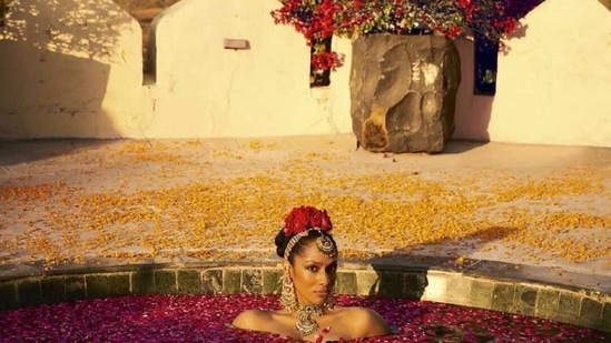 In one of the shots, Masaba Gupta can be seen decked in Sabyasachi jewellery as she soaks in a pool filled with rose petals.(Instagram )