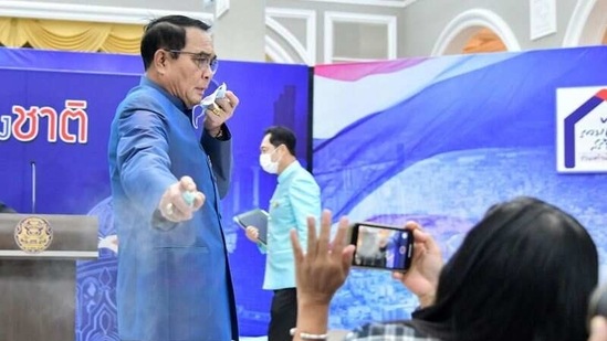 Thai PM Prayuth Chan-ocha sprays hand sanitiser at front row journalists to avert answering questions on the latest Cabinet reshuffle.(via REUTERS)