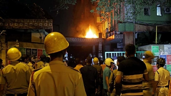 Firefighters and locals stand and watching fire after it broke out on the 13th floor of a multi-storeyed building and housing offices of the Railways, on Strand Road in Kolkata on Monday. (ANI Photo) Firefighters and locals stand and watching fire after it broke out on the 13th floor of a multi-storeyed building and housing offices of the Railways, on Strand Road in Kolkata on Monday. (ANI Photo)