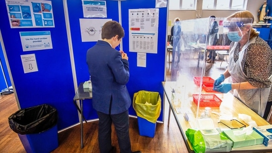 A pupil takes a Covid-19 test in the school hall at All Saints Catholic College in Dukinfield, Great Manchester, UK. (Bloomberg) A pupil takes a Covid-19 test in the school hall at All Saints Catholic College in Dukinfield, Great Manchester, UK. (Bloomberg)