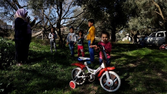 Tayyibe Demirel with children in Turgut village, near Yatagan. The Health and Environment Alliance (HEAL), a European non-profit organisation measuring the impact of pollution estimated that the healthcare costs of coal power generation in Turkey is up to 5.9 billion euros per year, Reuters reported.(Umit Bektas / REUTERS)