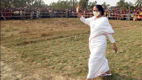 West Bengal chief minister Mamata Banerjee waves to supporters as she arrives to address a public meeting in Nandigram on Tuesday. (ANI)