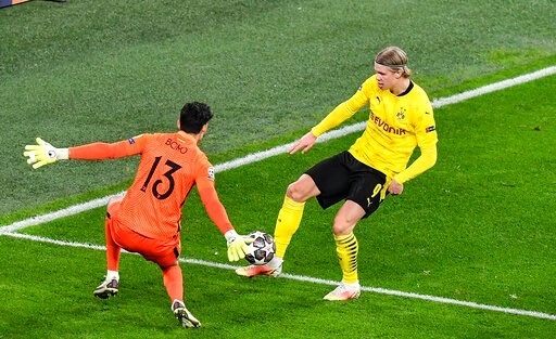 Dortmund's Erling Haaland, right, scores a goal against Sevilla's goalkeeper Yassine Bono that was turned into a penalty after video review during the Champions League, round of 16, second leg soccer match between Borussia Dortmund and Sevilla FC Dortmund's Erling Haaland, right, scores a goal against Sevilla's goalkeeper Yassine Bono that was turned into a penalty after video review during the Champions League, round of 16, second leg soccer match between Borussia Dortmund and Sevilla FC