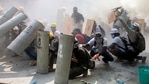 Protesters take cover as they clash with riot police officers during a protest against the military coup in Yangon, Myanmar(Reuters) Protesters take cover as they clash with riot police officers during a protest against the military coup in Yangon, Myanmar(Reuters)