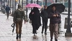 People walks along a sidewalk during a rainfall in Srinagar on March 10, 2021. (Photo by Tauseef Mustafa / AFP)(AFP) People walks along a sidewalk during a rainfall in Srinagar on March 10, 2021. (Photo by Tauseef Mustafa / AFP)(AFP)