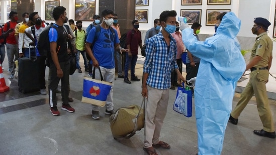 A health worker checks the temperature of passengers at the CSMT Railway platform, in Mumbai on Thursday. (ANI Photo) A health worker checks the temperature of passengers at the CSMT Railway platform, in Mumbai on Thursday. (ANI Photo)