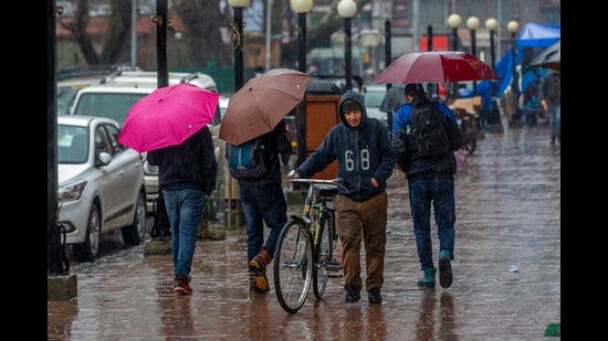 Kashmir people walk in the rainfall in Srinagar on Thursda . Many areas in the higher reaches of Kashmir Valley received fresh snowfall while the plains, including Srinagar, experienced rain, with the Meteorological Department predicting more showers over the next two days, according to reports. (AP) Kashmir people walk in the rainfall in Srinagar on Thursda . Many areas in the higher reaches of Kashmir Valley received fresh snowfall while the plains, including Srinagar, experienced rain, with the Meteorological Department predicting more showers over the next two days, according to reports. (AP)