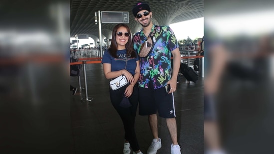 Rohanpreet Singh went for a comfy graffiti shirt and a pair of shorts. He wore a fanny pack across his torso and white sneakers while twinning with wife. (Varinder Chawla) Rohanpreet Singh went for a comfy graffiti shirt and a pair of shorts. He wore a fanny pack across his torso and white sneakers while twinning with wife. (Varinder Chawla)
