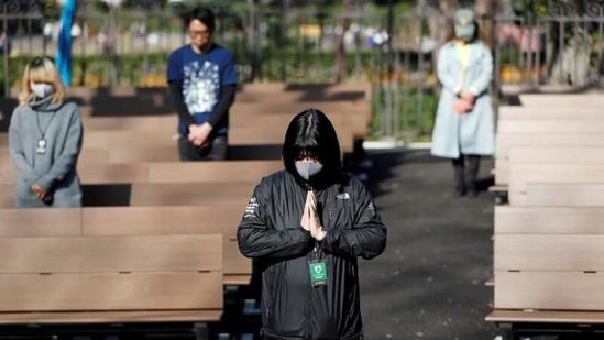 People wearing face masks due to the coronavirus disease (COVID-19), observe a moment of silence at 2:46 p.m. (0546 GMT), the time when the 9.0-magnitude earthquake struck off Japan's coast in 2011, during a memorial service at Hibiya Park in Tokyo, Japan, on March 11, 2021, to mark the ten-year anniversary of the earthquake and tsunami that killed thousands and set off a nuclear crisis.(Issei Kato / REUTERS)