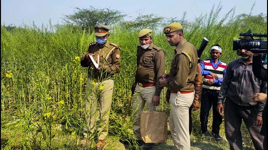 Police personnel investigate the site where bodies of two minor Dalit girls and another in critical condition were found in a field in February in Unnao, Uttar Pradesh. (PTI) Police personnel investigate the site where bodies of two minor Dalit girls and another in critical condition were found in a field in February in Unnao, Uttar Pradesh. (PTI)