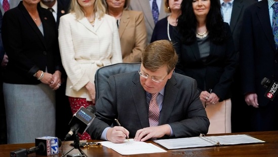 Mississippi Gov. Tate Reeves signs the first state bill in the US this year to ban transgender athletes from competing on female sports teams. (AP) Mississippi Gov. Tate Reeves signs the first state bill in the US this year to ban transgender athletes from competing on female sports teams. (AP)