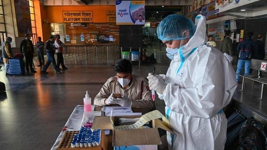 Medical workers get ready to take swab samples of passengers arriving from other cities for a Rapid Antigen Test (RAT) Covid-19 test in Delhi. (AFP file photo) Medical workers get ready to take swab samples of passengers arriving from other cities for a Rapid Antigen Test (RAT) Covid-19 test in Delhi. (AFP file photo)