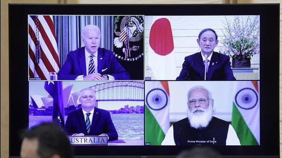 US President Joe Biden, top left, Yoshihide Suga, Japan's prime minister, top right, Scott Morrison, Australia's prime minister, bottom left, and Narendra Modi, India's prime minister, on a monitor during the virtual Quadrilateral Security Dialogue (Quad) meeting at Suga’s official residence in Tokyo, Japan on March 12, 2021. (Bloomberg)