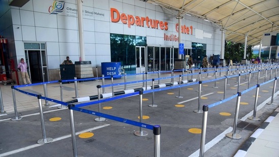 Markers placed to ensure social distancing outside the departure gates of Mumbai Airport, on March 9. The Panvel civic body also gave directives to shut down educational institutions and banned sports tournaments and competitions till March 22, HT reported.(PTI )
