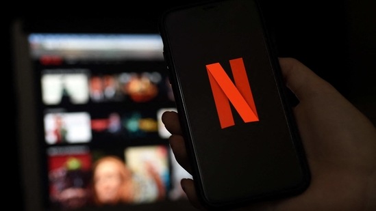 In this file photo illustration a computer and a mobile phone screens display the Netflix logo on March 31, 2020 in Arlington, Virginia.(AFP)