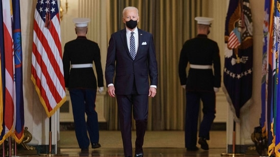US President Joe Biden walks from the State Dining Room to the East Room to deliver an address to the nation on the anniversary of the start of the Covid-19 pandemic, in the East Room of the White House in Washington, DC on March 11, 2021. (AFP) US President Joe Biden walks from the State Dining Room to the East Room to deliver an address to the nation on the anniversary of the start of the Covid-19 pandemic, in the East Room of the White House in Washington, DC on March 11, 2021. (AFP)