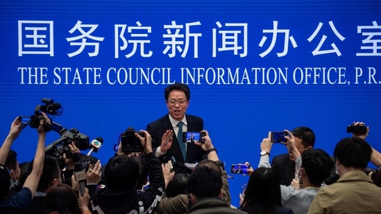 Zhang Xiaoming (C), Executive Deputy Director of the Hong Kong and Macau Affairs Office of the State Council, gestures in front of journalists at the end of a State Council press conference on Hong Kong electoral reform in Beijing on March 12, 2021. (NICOLAS ASFOURI / AFP)