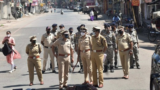 In Nagpur, police personnel stand guard during the weekend lockdown in February. (PTI) In Nagpur, police personnel stand guard during the weekend lockdown in February. (PTI)