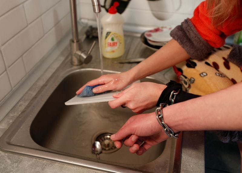 Viktoria Pustovitova, 28, washes the dishes as Alexandr Kudlay, 33, stands next to her in their apartment in Kharkiv, Ukraine. (REUTERS)