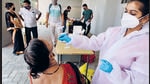 A BMC healthcare workers collects swab samples of residents at Topiwala Hospital, Goregaon. (Satish Bate/HT Photo) A BMC healthcare workers collects swab samples of residents at Topiwala Hospital, Goregaon. (Satish Bate/HT Photo)