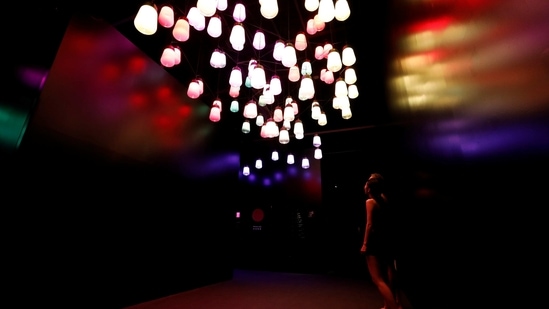 Staffs of teamLab wearing swimming suits look at artwork titled as Array and Spiral of Resonating Lamps during a demonstration of TikTok teamLab Reconnect, digital artwork combined with sauna, ahead of its opening to the public this month in Tokyo, Japan, March 13, 2021. REUTERS/Kim Kyung-Hoon (REUTERS)