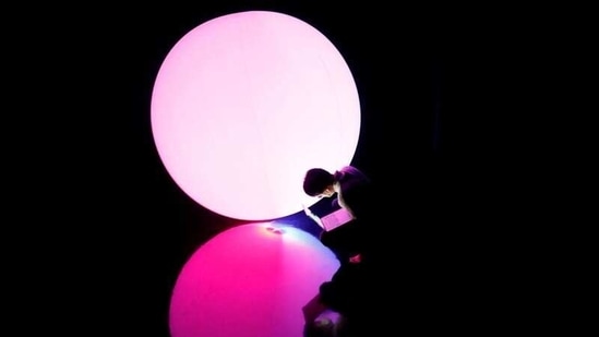 A staff of teamLab checks a digital artwork titled as Levitation during a demonstration of TikTok teamLab Reconnect, digital artwork combined with sauna, ahead of its opening to the public this month in Tokyo, Japan, March 13, 2021. (REUTERS)