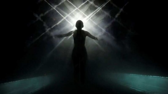 A staff of teamLab wearing a swimming suit stands inside a digital artwork combined with light, mist and sound during a demonstration of TikTok teamLab Reconnect, digital artwork combined with sauna, ahead of its opening to the public this month in Tokyo, Japan, March 13, 2021.  (REUTERS)
