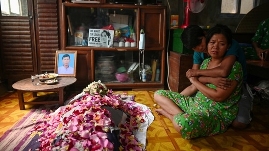 Family members break down near the body of Aung Than, 41, who was killed during a raid by security forces, at their home in Thaketa, Yangon, on March 13. One person was killed in the central town of Pyay and two died in police firing in Yangon overnight, Reuters reported citing domestic media reports.(REUTERS)