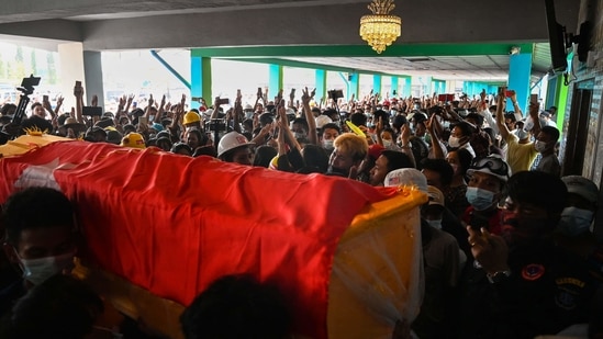 Mourners do the three-finger salute as the coffin of Chit Min Thu, a protester who died during a demonstration against the military coup on March 11, is carried past during his funeral in Yangon on March 13. "The security forces initially stopped the ambulance from reaching the injured people and only allowed it later," a 23-year-old protester in Pyay told Reuters.(AFP)