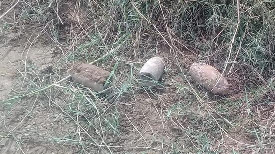 The bombs lying on the dry river bed near Panjali village on the Ambala-Kurukshetra border on Saturday. (HT Photo)