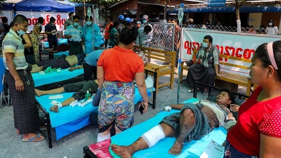 Protesters, who were shot with live rounds during a demonstration against the military coup, receive medical attention at a makeshift medical centre in Mandalay on March 13.(AFP)