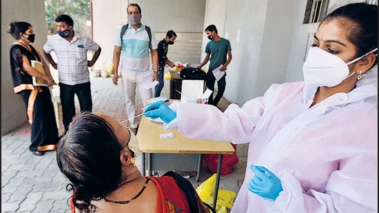 A BMC healthcare workers collects swab sample of residents at Topiwala Hospital, Goregaon. (Satish Bate/HT Photo) A BMC healthcare workers collects swab sample of residents at Topiwala Hospital, Goregaon. (Satish Bate/HT Photo)