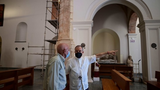 Monsignor Roberto González, the archbishop of San Juan, points as he and businessman Ricardo Gonzalez stand inside the San Jose Church after its reconstruction in San Juan, Puerto Rico, Tuesday, March 9, 2021. The $11 million restorations became a personal project for González that took nearly two decades to complete. (AP)
