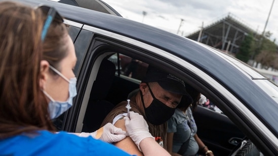 A nurse administers a shot at a Covid-19 mass vaccination site at Martinsville speedway in Ridgeway, Virginia on March 12, 2021. (AFP) A nurse administers a shot at a Covid-19 mass vaccination site at Martinsville speedway in Ridgeway, Virginia on March 12, 2021. (AFP)