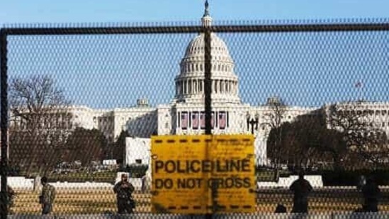 National guards are seen Wednesday, Jan. 13, 2021 on a fence that was erected to reinforce security at the Capitol in Washington. (AP) National guards are seen Wednesday, Jan. 13, 2021 on a fence that was erected to reinforce security at the Capitol in Washington. (AP)