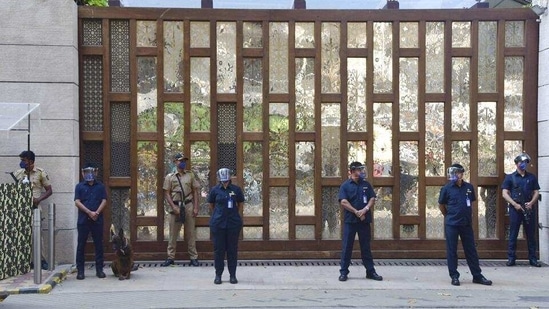 Police personnel stand guard at Mukesh Ambani's residence, a day after explosives were found in an abandoned car in its vicinity, in Mumbai on February 26. (PTI)