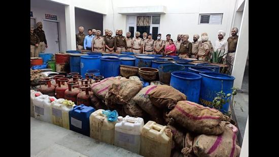 Members of the Amritsar rural police team after busting an illicit liquor manufacturing unit at Kotli Sakka village in Ajnala sub division on Saturday. (HT Photo)