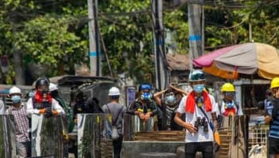 Anti-coup protesters gather with makeshift shields during a demonstration in Yangon, Myanmar, Friday, March 12, 2021.