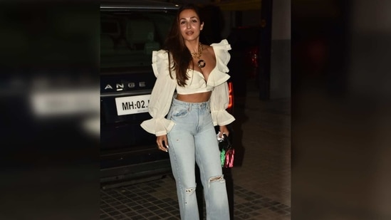 Malaika Arora went with the classic blue and white combination. The actor wore a beautiful white plunging neckline crop top featuring puffy sleeves.(Varinder Chawla)