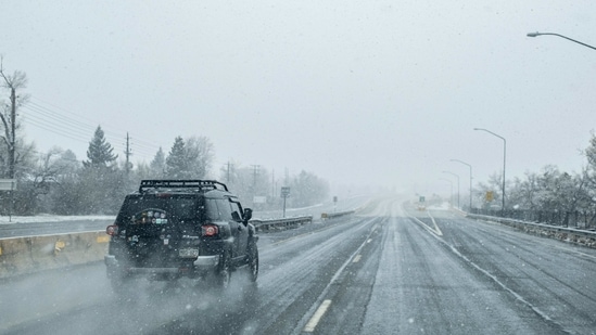 A vehicle drives down US-36 during a winter storm in Boulder, Colorado, U.S., on Saturday, March 13, 2021. (Bloomberg Photo )