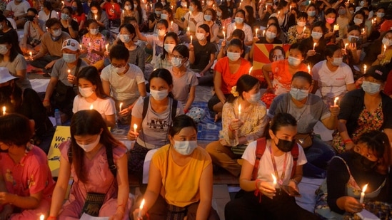 Protesters attend a candlelight night rally in Yangon, Myanmar on March 13, 2021. (AP Photo) Protesters attend a candlelight night rally in Yangon, Myanmar on March 13, 2021. (AP Photo)